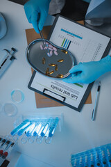Wall Mural - a scientist is testing various pills in order to improve their quality an effectiveness in the labor