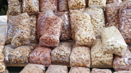 Canvas Print - many mixed nuts in a plastic packet on shelf 