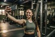 © nilawan - Smiling Woman Taking a Selfie at the Gym.