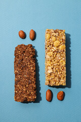 Wall Mural - Delicious granola bars with nuts on a blue background