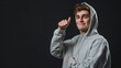 © paper later - Smiling Young Man in Grey Hoodie Gesturing with Thumb Up