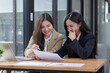 © SOMKID - Two Asian businesswomen working on laptop computer with analyzing financial charts in the modern office, Business financial documents and planning idea project concept.
