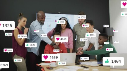 Wall Mural - Social media notifications animation over diverse business team collaborating in office