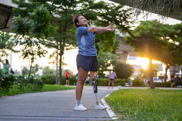 woman with prosthetic leg from amputation is stretching her leg muscle during warm up exercise work 