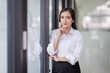 © David - Happy confident asian professional business woman standing at work in office arms crossed looking away, asian businesswoman leader executive thinking of future success.
