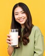 © AnggiDimas - asian woman holding glass of milk