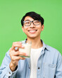 © AnggiDimas - Portrait young man holding glass of milk happy smiling