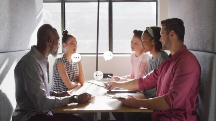 Wall Mural - Business meeting with speech bubble animation over diverse team discussing ideas