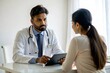 © N7 - Indian Doctor Consulting Female Patient in Clinic Office