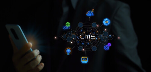 CMS, Content management system concept for business website management. Businessman showing glowing neon line of content management system icons on virtual screen.