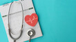 © chinnarach - close up top view on red heart symbol and stethoscope on calendar with over blue background for design about ads or banner of doctor appointment and health checkup following personal lifestyle concept