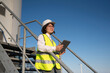 © Westend61 - Smiling engineer with tablet PC leaning on wind turbine railing