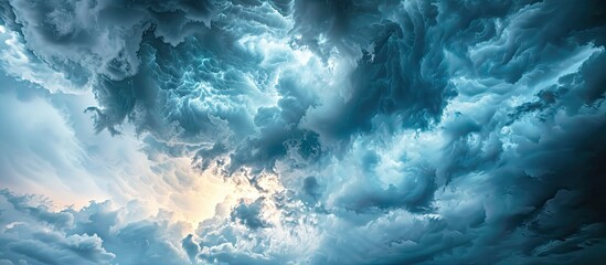 Poster - Dramatic storm clouds in dark grey contrast sharply with a blue sky background creating a striking scene with thunderstorm elements Copy space image