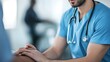 © Pascal - Male Nurse Comforting Patient A muscular man in scrubs holding a patient's hand with a reassuring expression, embodying strength and compassion