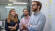 © bird_saranyoo - Team members standing around a whiteboard filled with diagrams, engaging in a dynamic discussion about project strategies.