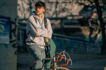 Poster - young man on the street riding on vintage bicycle