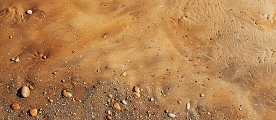 Sticker - Brown sandy beach with small stones creating a textured background ideal for use as a copy space image