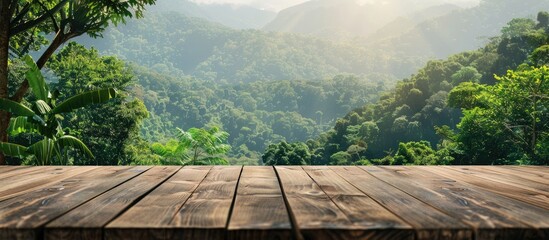 Poster - Wooden table with a blurred backdrop of mountains and lush greenery providing a copy space image for displaying products against a stunning forest landscape