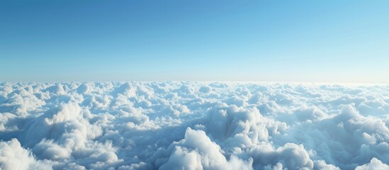 Poster - Scenic aerial view with serene white clouds against a clear blue sky visible through a plane window offering a tranquil copy space image