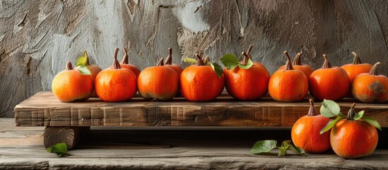 Poster - Wooden board featuring luscious ripe persimmons with a background suitable for adding text or graphics copy space image