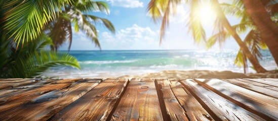 Poster - A perfect summer scene with a sunny tropical beach and palm trees in the blurred background creating an ideal setting for a wooden table showcasing products with a copy space image