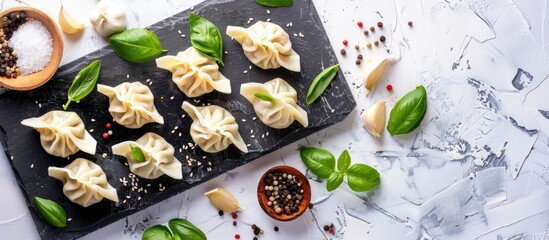 Poster - Blackboard with uncooked dumplings and basil on a white backdrop creating a visually appealing copy space image