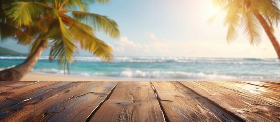 Poster - A wooden table set against a blurred summer beach with palm trees creating a scenic backdrop for showcasing summer products with copy space image