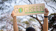 © ChayTee - Go green people young woman hand raised showing save the earth planet world care banner poster sign in city nature tree sun light sunset. Plastic free issues Protect future asian hope net zero waste
