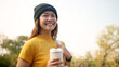 © ChayTee - Go green Gen Z woman asia young people smile looking at camera protect save the earth planet world care in city tree public park. Asian hope net zero waste reduce social issues by reuse eco tote bag.