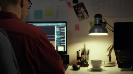 A programmer works on a laptop, writes code for a new program that is connected with neural networks, artificial intelligence, his task is to implement a framework of restrictions for the program