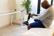 © Wavebreak Media - Man with prosthetic leg adjusting socket while sitting on therapy table, copy space