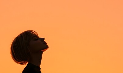 Wall Mural - Silhouette of young blonde with short hair on orange sunset background, Generative AI