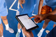 © WavebreakMediaMicro - Basketball male coach using tablet to discuss game strategy with female players
