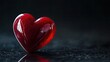 © BozStock - A red heart sits on a dark surface.