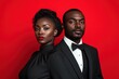 © Anna - Elegant couple in formal attire on red backdrop.