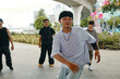 © DragonImages - Group of friends engaging in street dance under urban bridge surroundings Participants wearing casual clothing, performing various moves while having fun