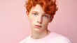 © ALA - Portrait of a happy serious red-haired confident teenage guy with perfect skin, light pink background, banner.