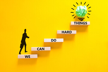 Wall Mural - We can do hard things symbol. Concept words We can do hard things on wooden blocks. Beautiful yellow table yellow background. Businessman icon. Business, we can do hard things concept. Copy space.