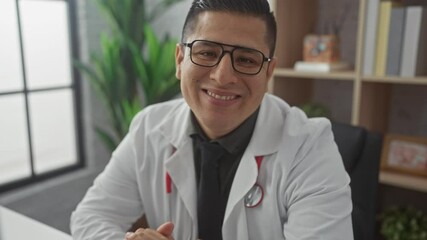 Sticker - A smiling hispanic man in a white lab coat with a stethoscope posing in a medical clinic's office.