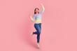 © Tetiana - Full length body size view of nice attractive lovely glad cheerful wavy-haired girl jumping having fun rising hands up isolated on bright vivid shine vibrant background