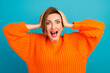 © Tetiana - Image of shocked excited young lady standing isolated over blue background