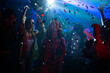 © Videophilia - Group of friend celebrating and dancing in night club with illuminated neon night lights and falling confetti