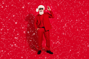 Poster - Full size photo of retired bearded grey haired man make okay sign xmas gentleman isolated on red color background