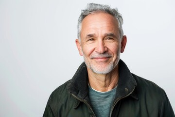 Happy older man with gray hair smiling on white background.