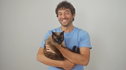 Sticker - A cheerful man holding a siamese cat against a white background, depicting companionship and love for pets.