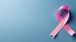© Katsyarina - Pink ribbon of awareness on the background to copy the space. A month of fighting breast cancer. Cancer prevention