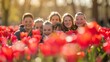 © Tamara - Joyful Kids Smiling Among Bright Red Tulips in a Beautiful Park Setting