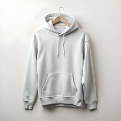 Wall Mural - Blank white hoodie mockup hanging on a wooden hanger.