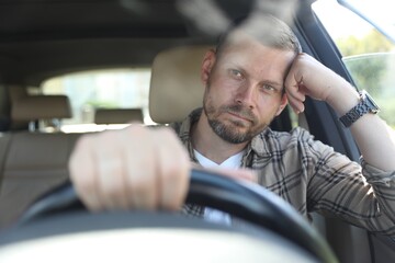 Wall Mural - Man holding steering wheel while driving car, view through windshield