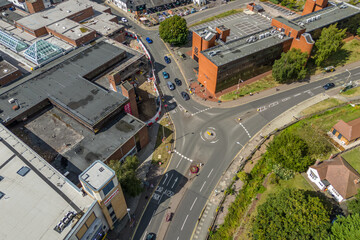 Aerial drone shot over cars driving on the road in Bishops Stortford in England